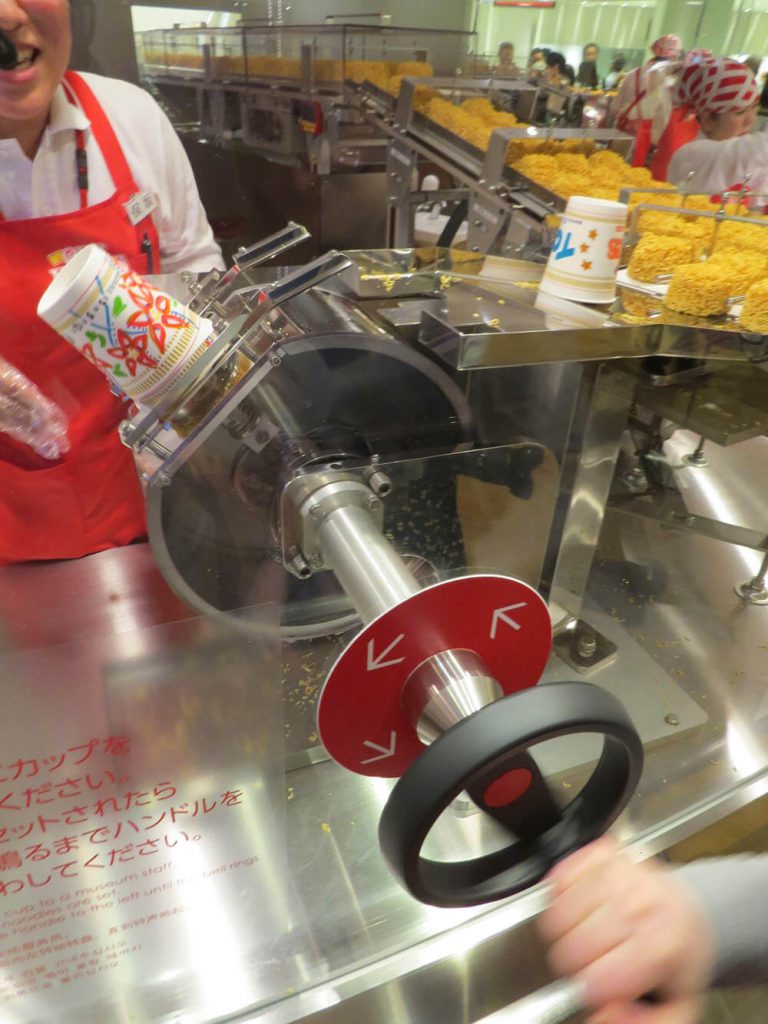 Noodles being added to container at the Cup Noodle Museum